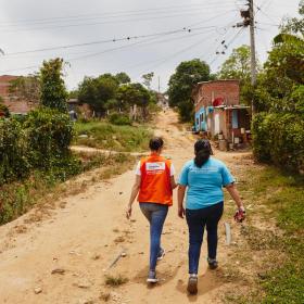 World Vision staff member walks on a dusty road in Colombia