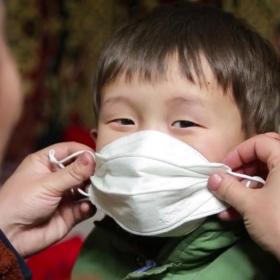 How we'll get there, mother puts mask on her child