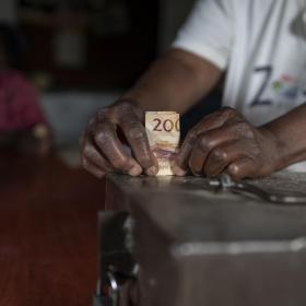Someone holding a 200 money bill
