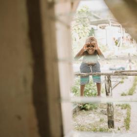 Child looking through window