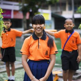 Girl from Thailand in orange shirt