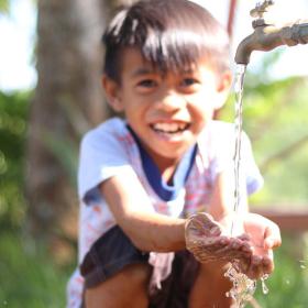 child washing his hands
