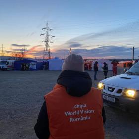 wv volunteer looks over refugee camp
