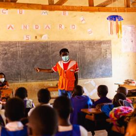 WVI staff member teaches classroom full of children