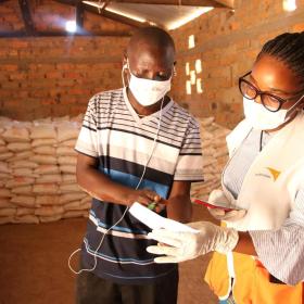 World Vision staff speaks with man