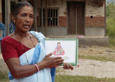 A child health worker holds a training document