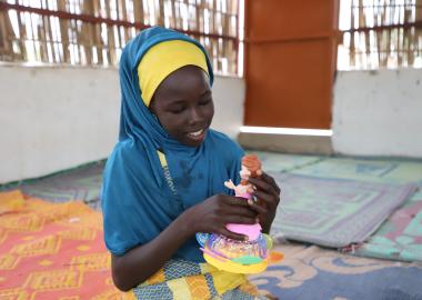 Fanna playing with her doll in the Child Friendly Space of Sayam Forage in Diffa, Niger Fanna playing with her doll in the Child Friendly Space of Sayam Forage in Diffa, Niger