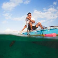 A fisherman in the Philippines uses a microloan to fund his small business
