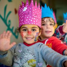 Children with face paint wearing crowns