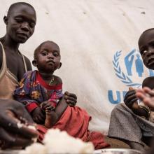 Amandru and her children eat the first proper meal they have eaten in a long time. World Vision and World Food Programme (WFP) serve hot meals to South Sudanese refugees in Uganda.