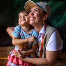 World Vision staff hugging girl