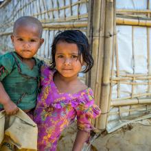 A girl holds her young brother