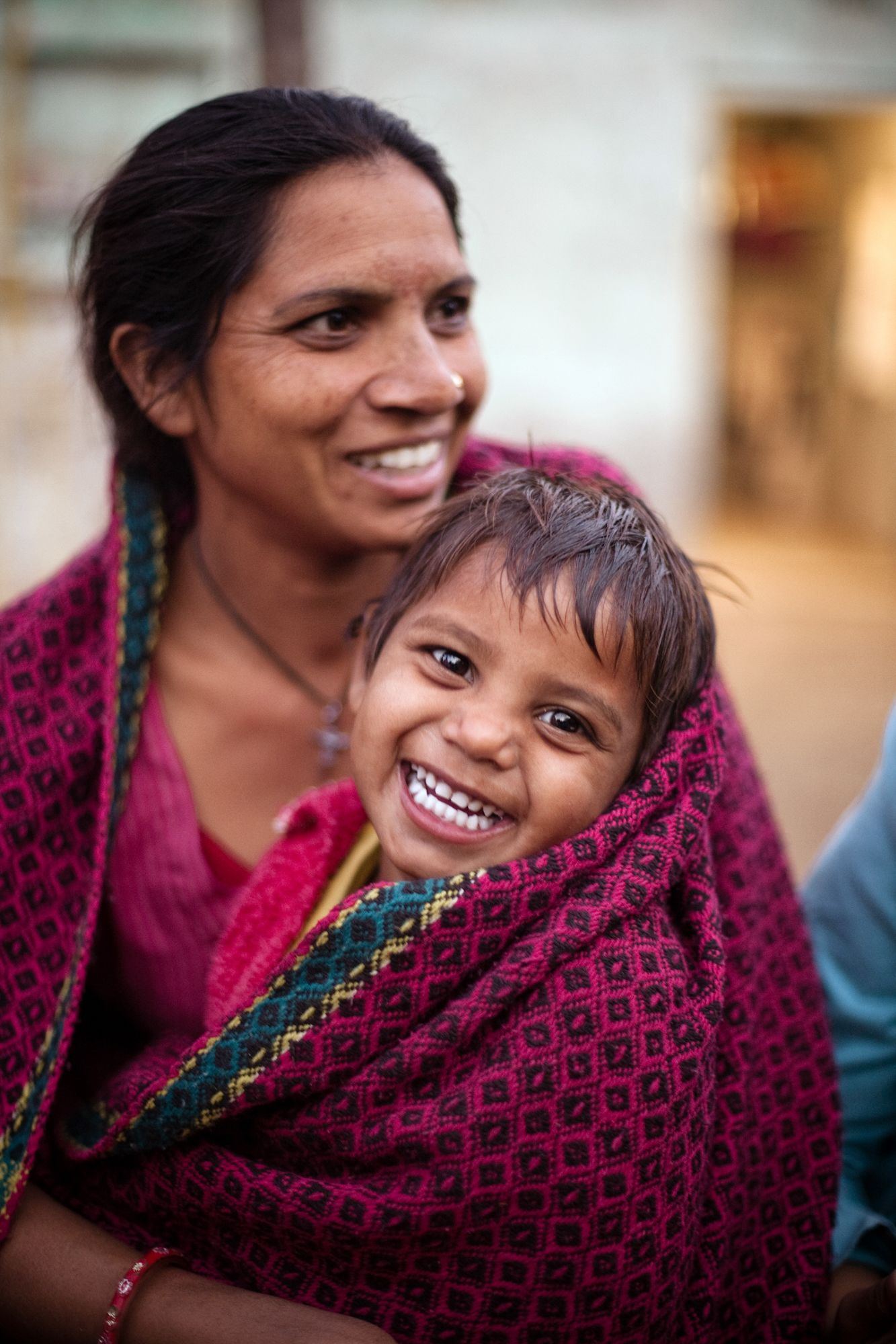 <alt="A mother holding her smiling child">